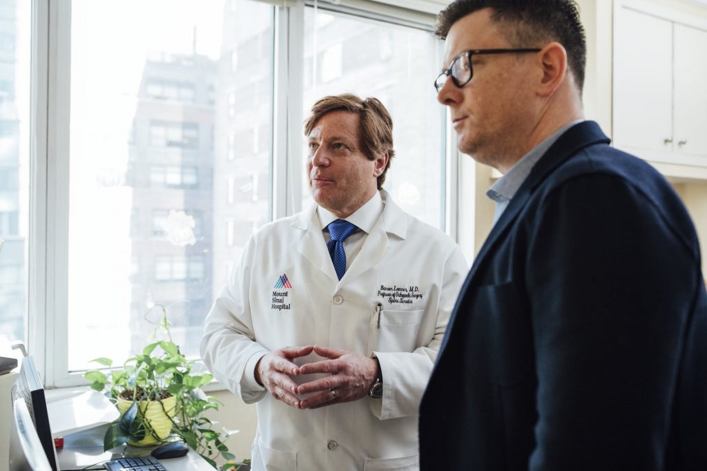 Two doctors discussing in hospital office.