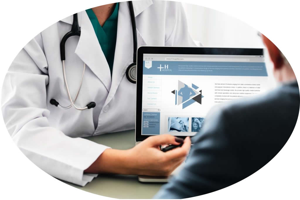 Doctor reviewing medical information on computer screen.