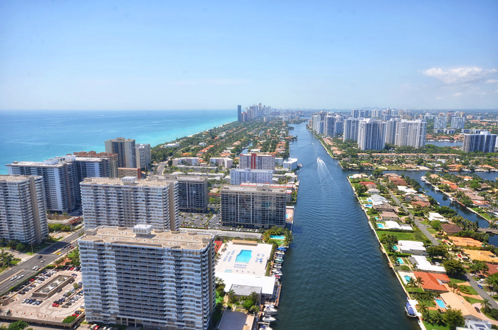 Coastal city skyline with buildings and blue ocean