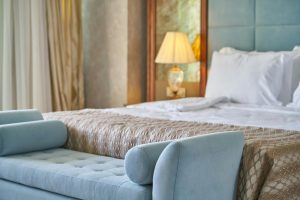 Luxurious bedroom with elegant bedspread and bedside lamp.