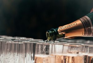 Pouring champagne into glasses at celebration event.